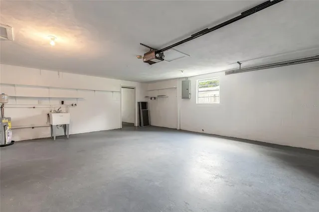 a kitchen with white cabinets and window