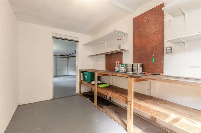 a view of a house with a small yard and a large tree