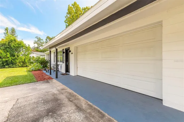 a view of a house with backyard and tree