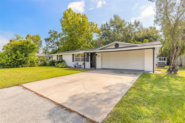 an aerial view of residential houses with outdoor space and swimming pool
