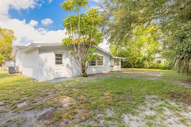 an aerial view of a house with a swimming pool yard and mountain view in back