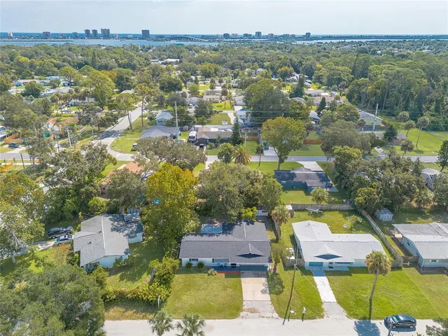 an aerial view of residential houses with outdoor space