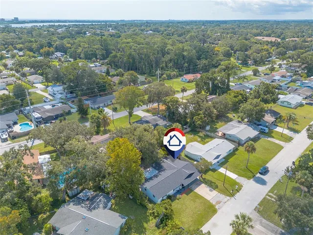 an aerial view of residential houses with outdoor space and river