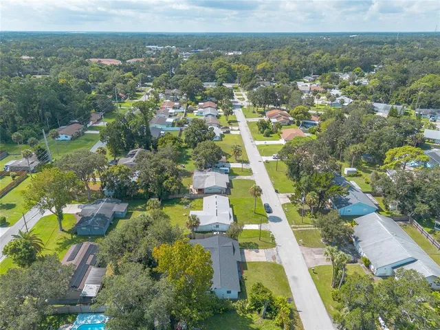 an aerial view of residential houses with outdoor space