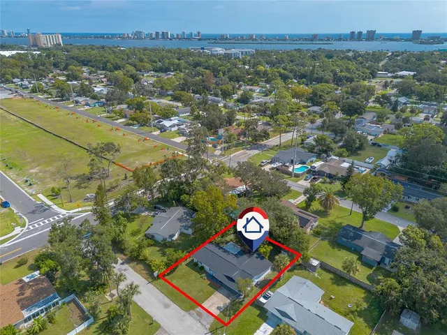a view of a house with backyard and sitting area