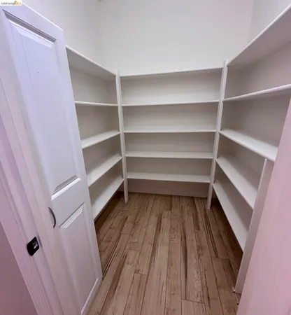 a view of walk in closet with empty racks