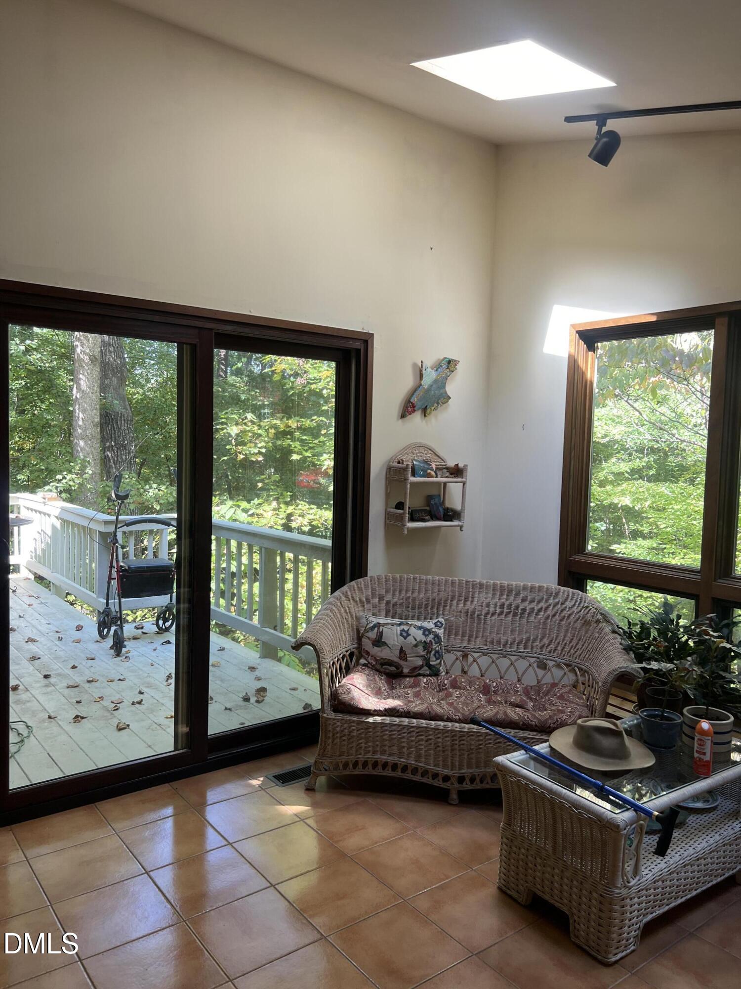 1800 Woodburn Road Durham, NC 27705 - Photo 3 of 6 a living room with furniture and a flat screen tv