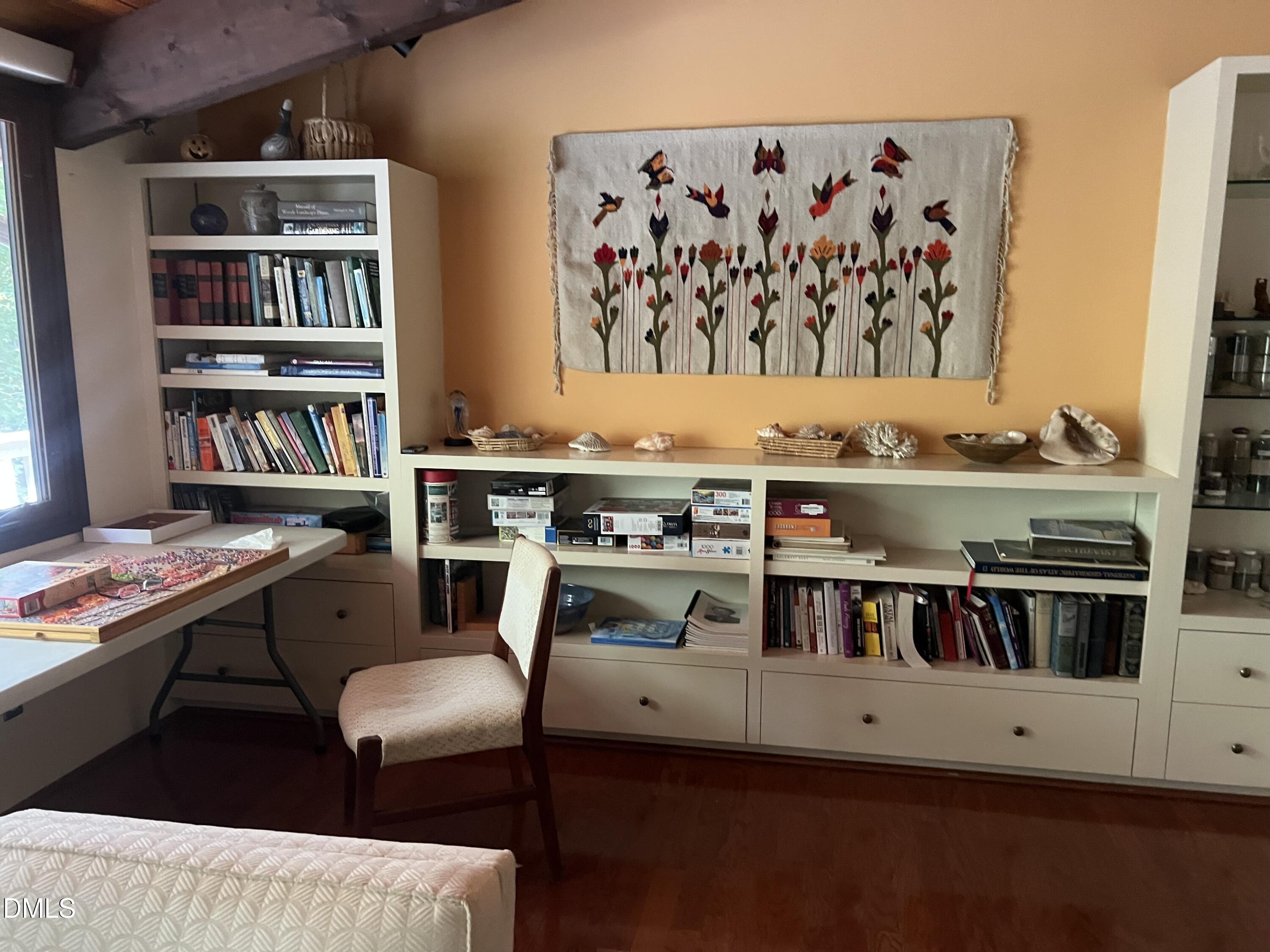 1800 Woodburn Road Durham, NC 27705 - Photo 4 of 6 a living room with furniture and book shelf
