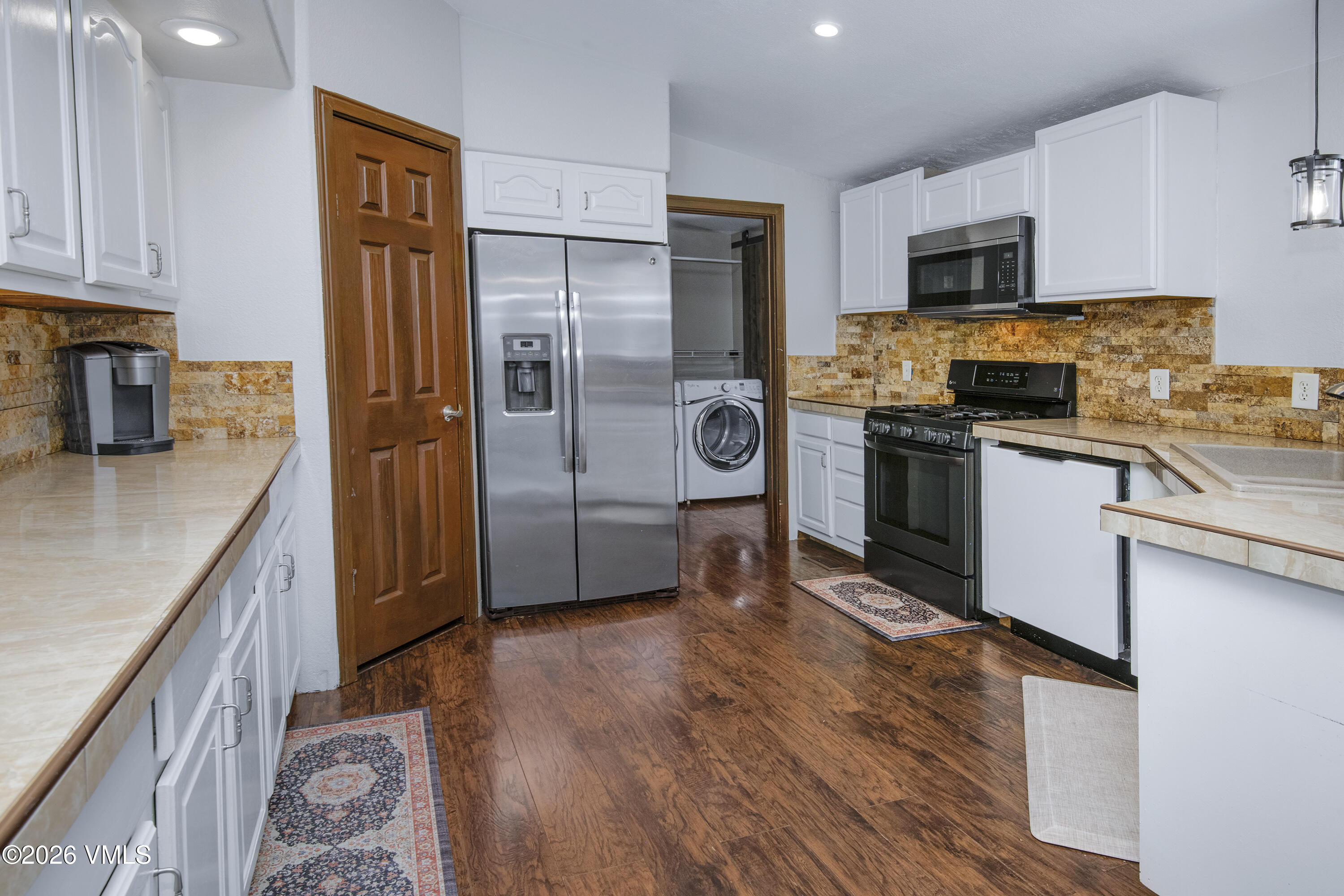 102 Cut Throat Loop Gypsum, CO 81637 - Photo 5 of 37 a kitchen with stainless steel appliances granite countertop a refrigerator a stove top oven a sink and dishwasher