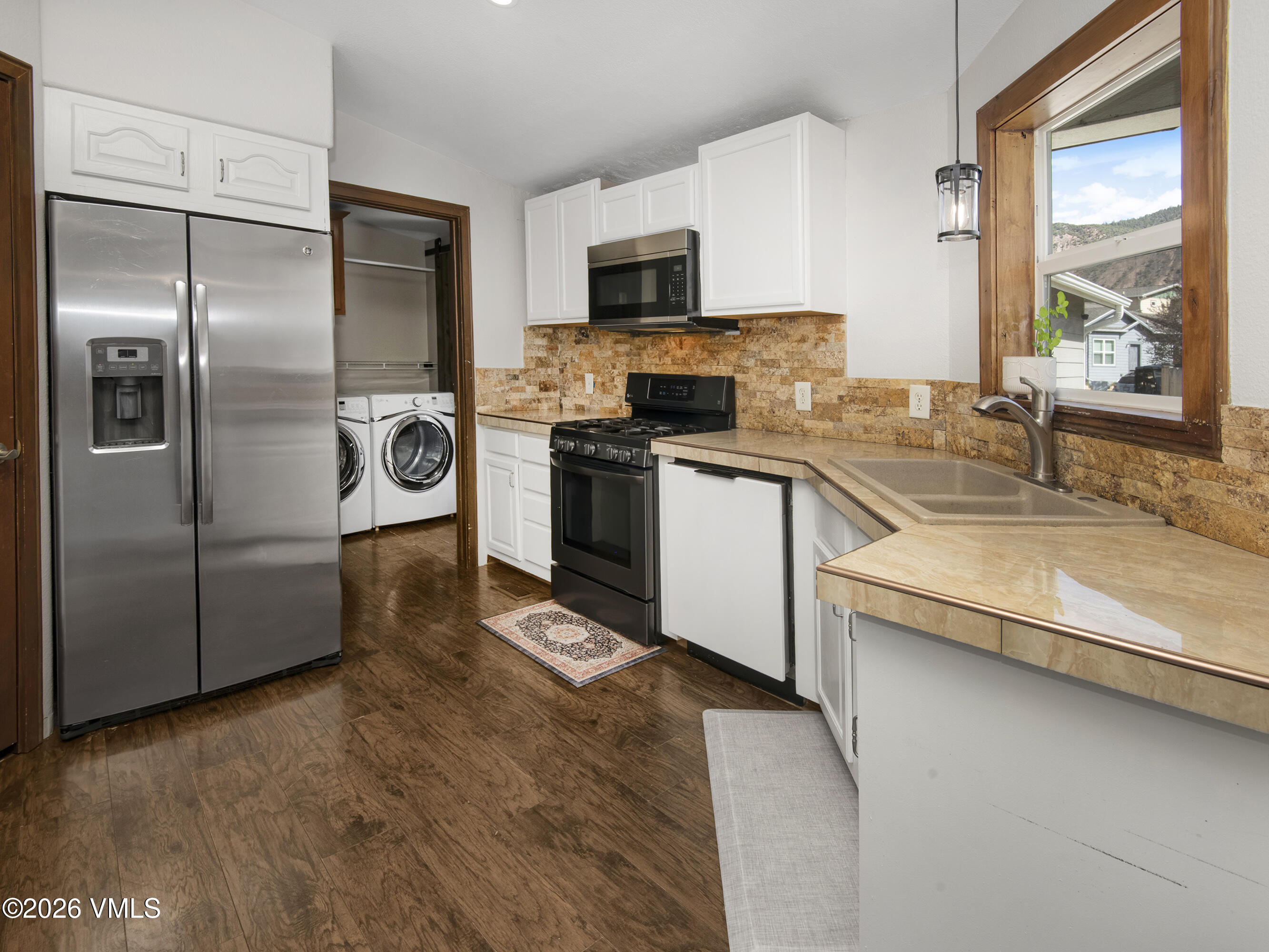 102 Cut Throat Loop Gypsum, CO 81637 - Photo 6 of 37 a kitchen with stainless steel appliances granite countertop a sink a stove and a refrigerator