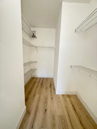 a view of a room with wooden floor