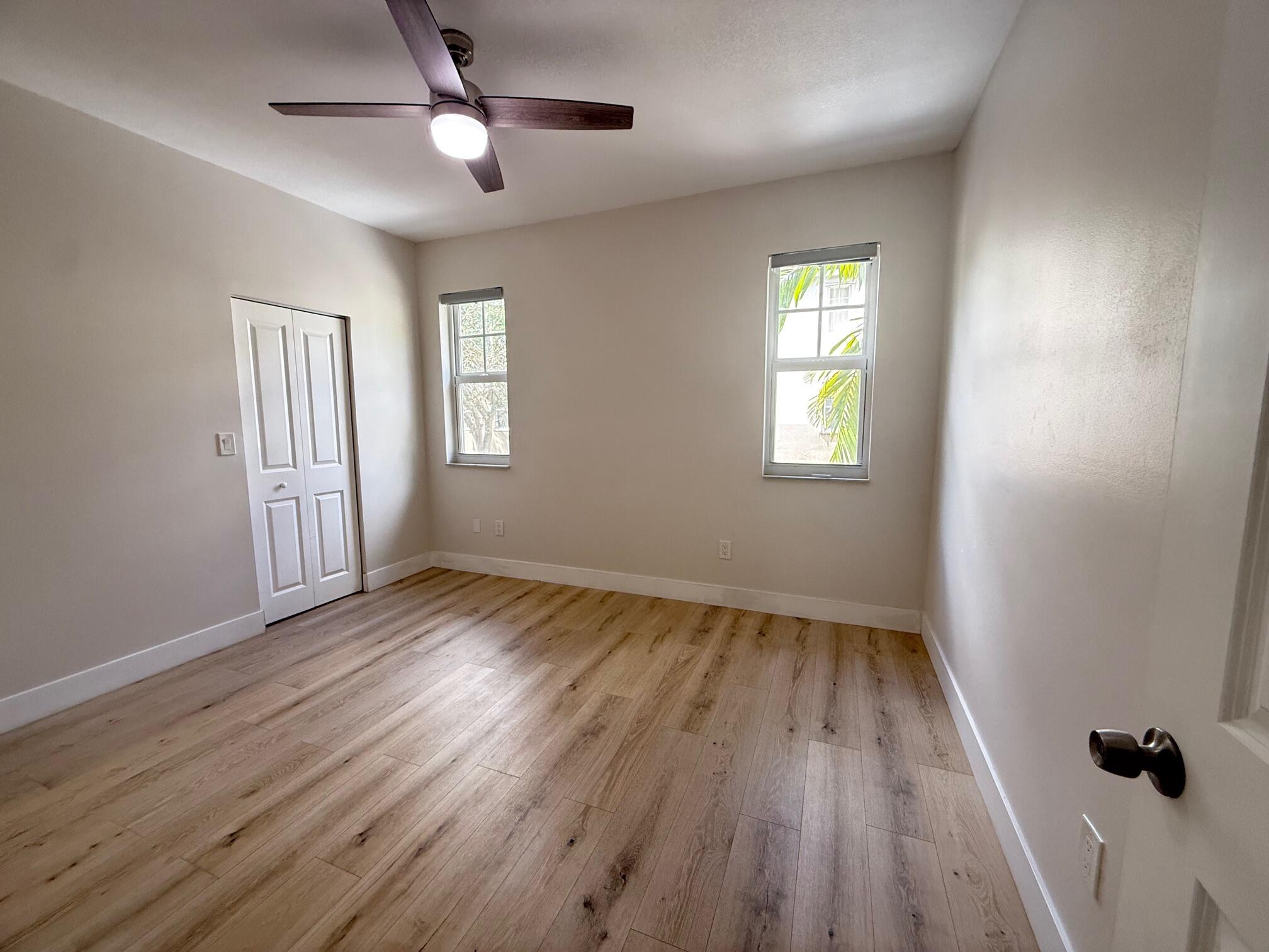 5860 West Sample Road, Unit 202 Coral Springs, FL 33067 - Photo 13 of 26 wooden floor in an empty room with a window