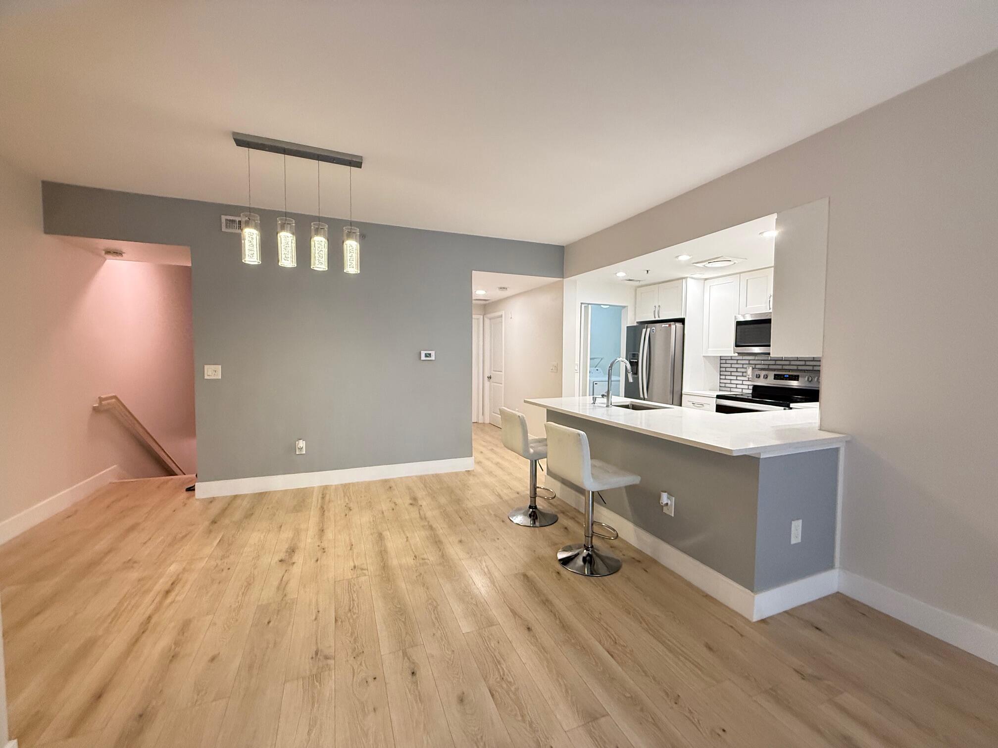 5860 West Sample Road, Unit 202 Coral Springs, FL 33067 - Photo 17 of 26 a room with a wooden floor and furniture