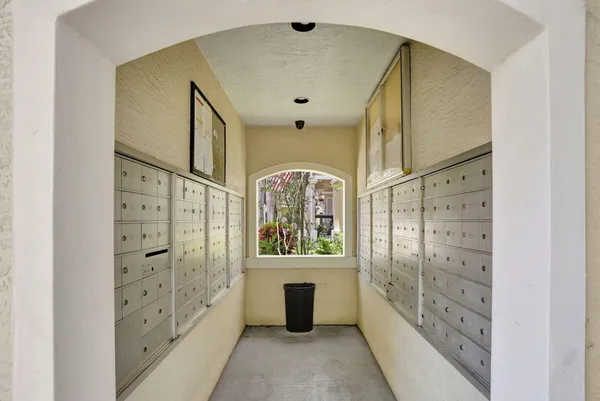 a large white kitchen with cabinets a sink and a wooden floor