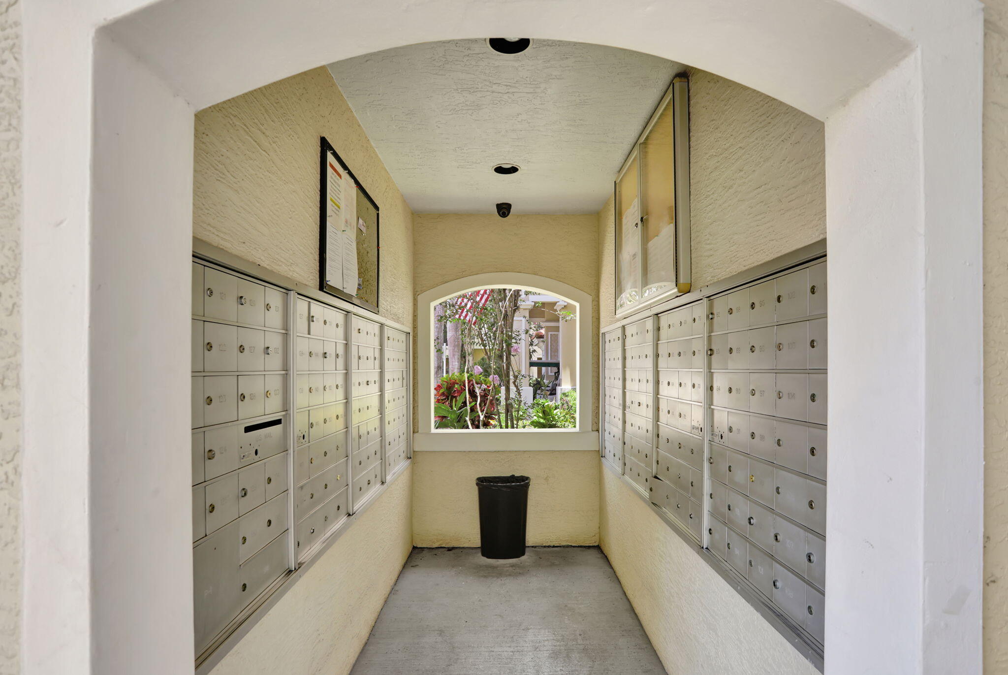 5860 West Sample Road, Unit 202 Coral Springs, FL 33067 - Photo 21 of 26 a large white kitchen with cabinets a sink and a wooden floor
