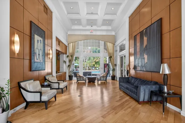 a living room with furniture a fireplace and large windows