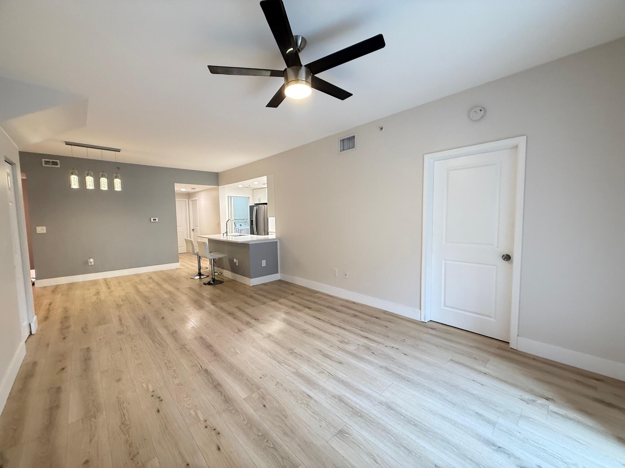 5860 West Sample Road, Unit 202 Coral Springs, FL 33067 - Photo 7 of 26 a view of empty room with wooden floor