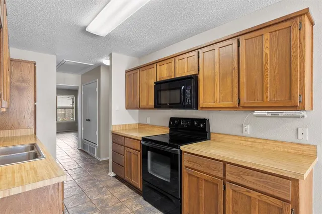 a kitchen with stainless steel appliances granite countertop a sink stove and cabinets
