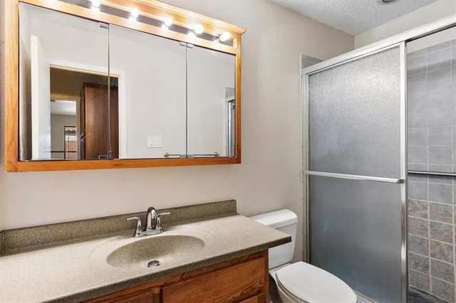 a bathroom with a sink a mirror and a shower
