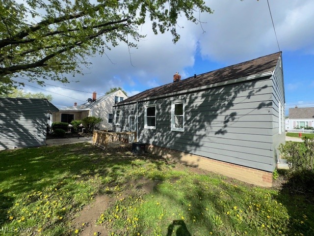 28846 Alton Road Wickliffe, OH 44092 - Photo 9 of 27 Back of property with a lawn and a chimney