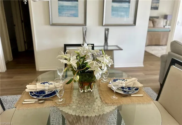 a dining room with furniture and wooden floor