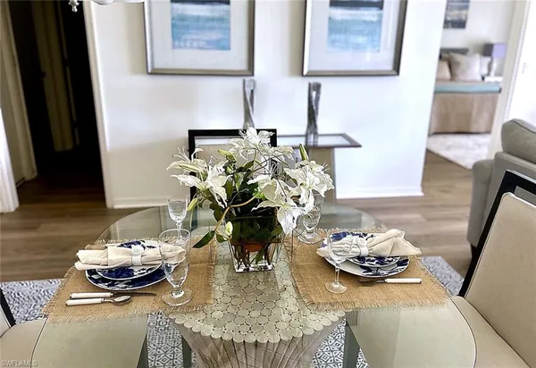 a dining room with furniture and wooden floor