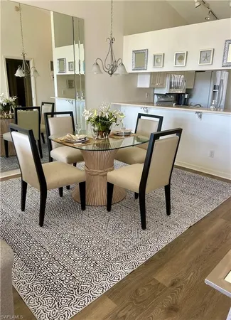 a living room with furniture and a dining table with kitchen view