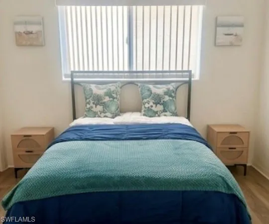 a view of a bedroom with bed and a window