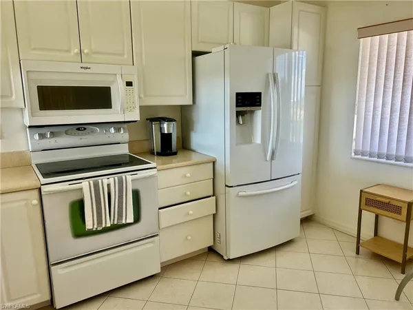 a kitchen with appliances and cabinets