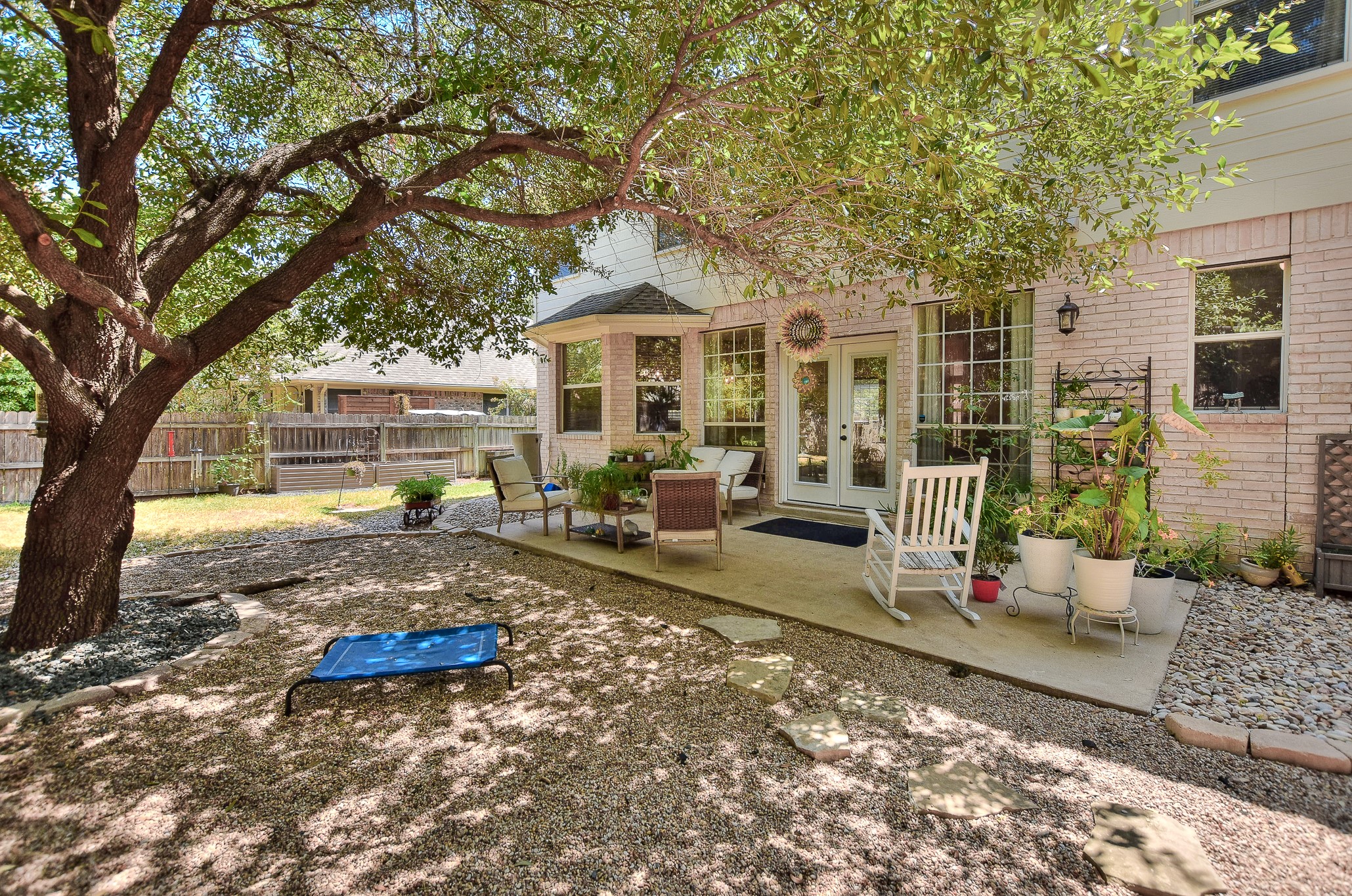 455 Logan Road Georgetown, TX 78628 - Photo 5 of 38 Patio extends across most of the back of the house.