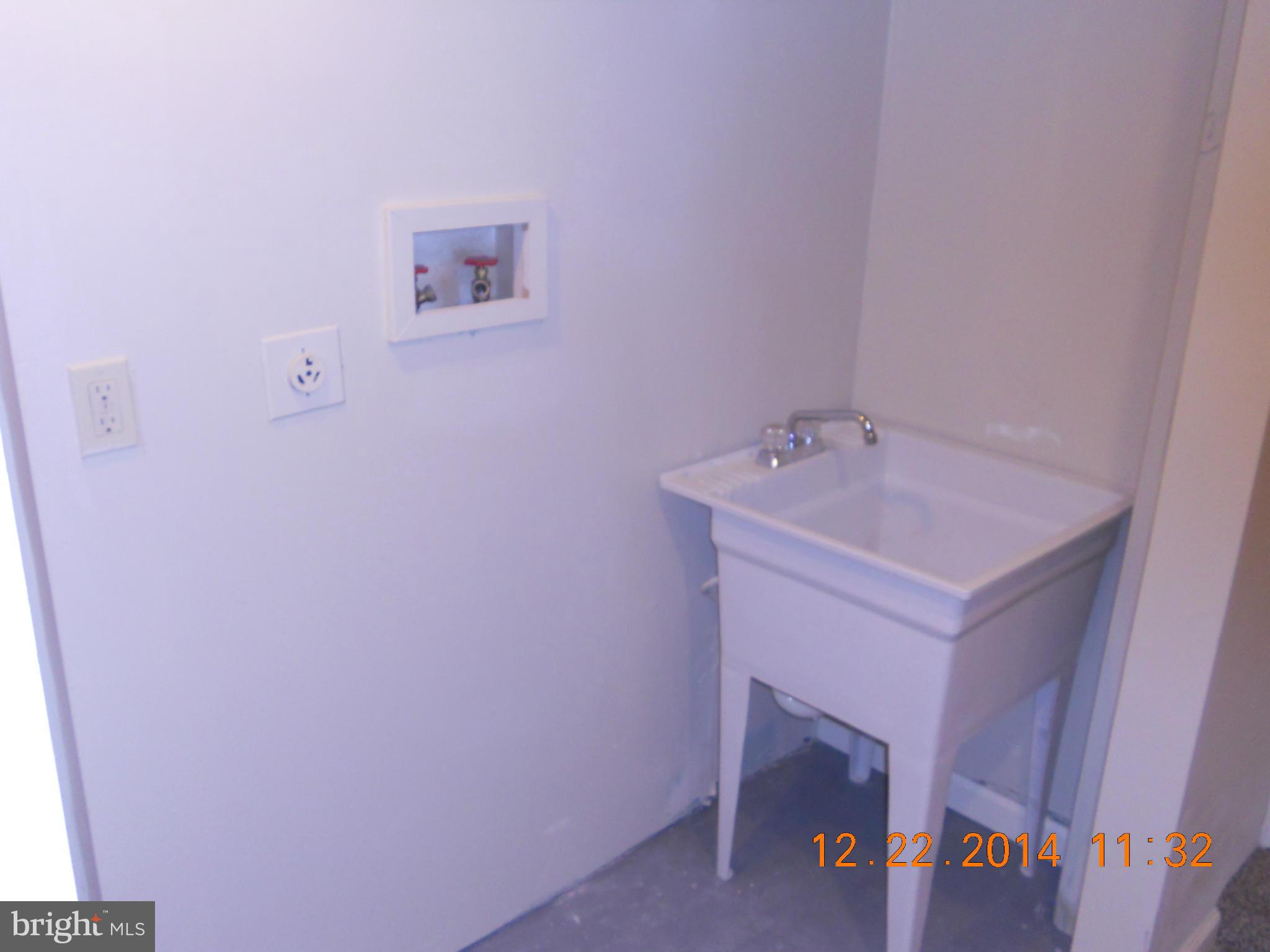 937 Coleridge Road Baltimore, MD 21229 - Photo 13 of 16 a utility room with a sink a vanity and a window