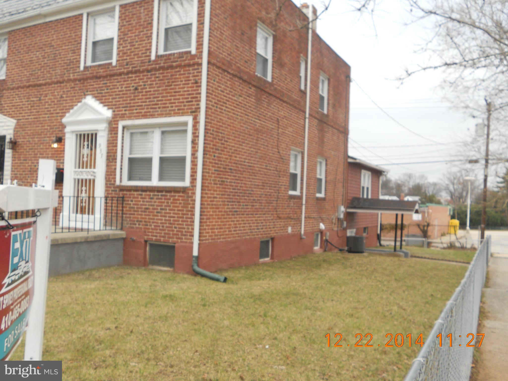 937 Coleridge Road Baltimore, MD 21229 - Photo 4 of 16 a view of a brick building next to a yard