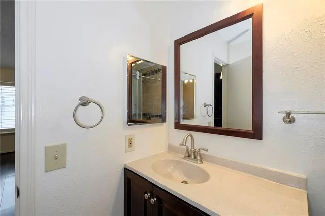 a bathroom with a sink vanity and a mirror