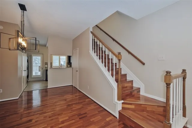 a view of entryway and hall with wooden floor