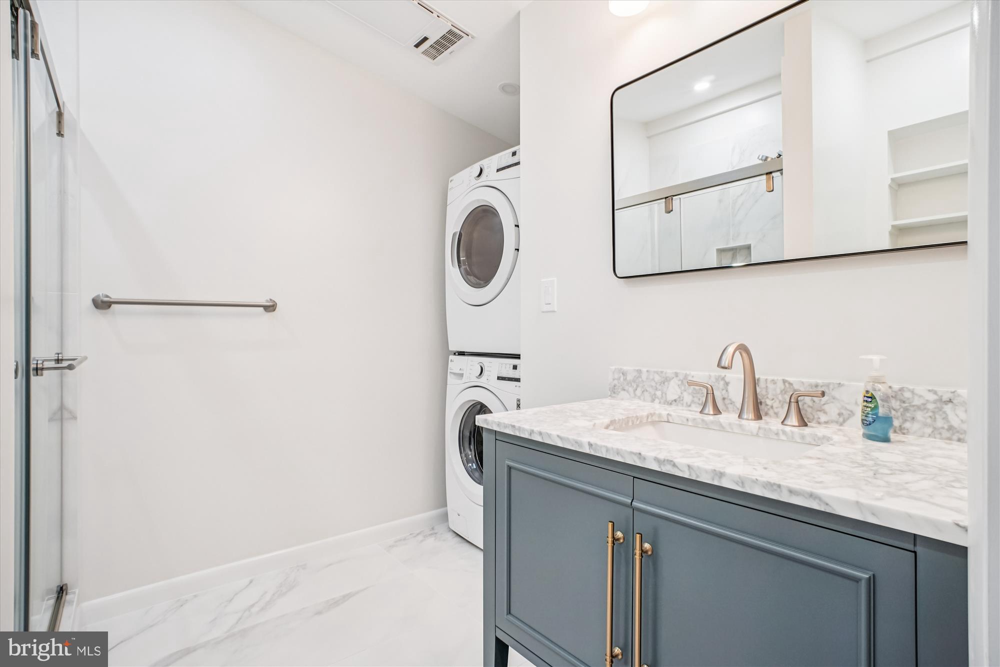 6022 Valley View Drive Alexandria, VA 22310 - Photo 14 of 50 a bathroom with a granite countertop sink and a mirror