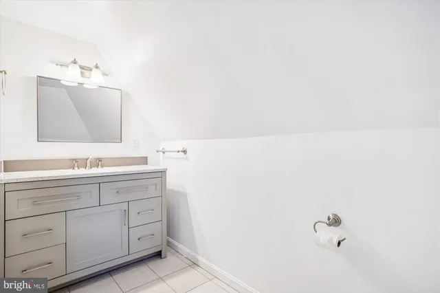a bathroom with a bathtub a window and a shower