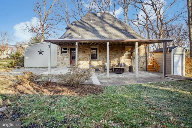a view of a backyard with a fence and trees