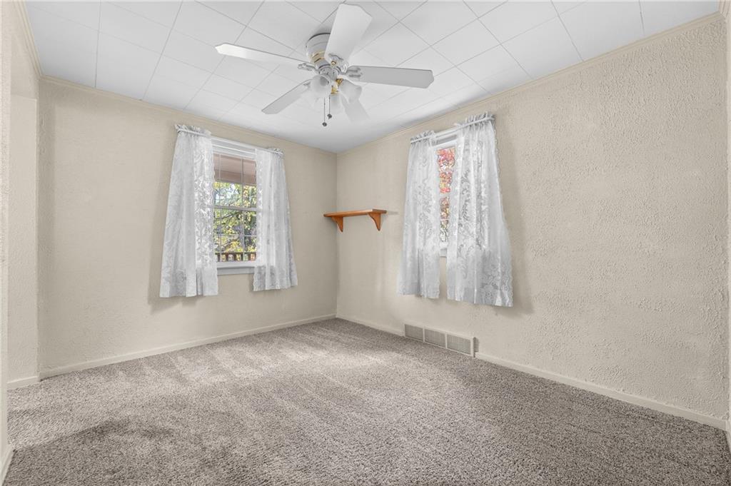 2058 Spring Valley Road Pittsburgh, PA 15243 - Photo 13 of 28 an empty room with windows and fan