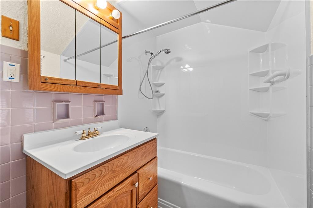 2058 Spring Valley Road Pittsburgh, PA 15243 - Photo 16 of 28 a bathroom with a sink vanity and a bathtub