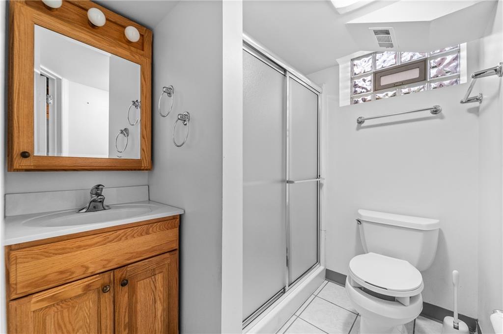 2058 Spring Valley Road Pittsburgh, PA 15243 - Photo 22 of 28 a bathroom with a granite countertop sink toilet and shower