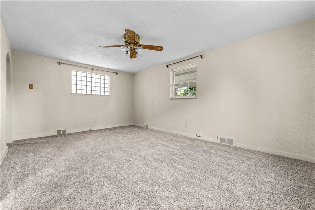 2058 Spring Valley Road Pittsburgh, PA 15243 - Photo 7 of 28 an empty room with windows and fan