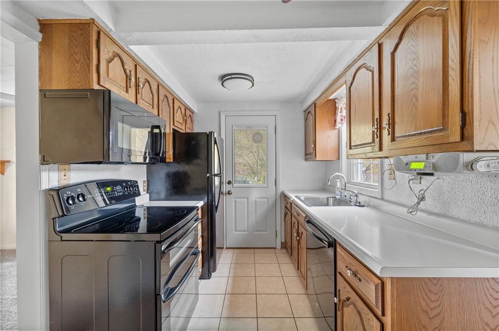 2058 Spring Valley Road Pittsburgh, PA 15243 - Photo 10 of 28 a kitchen that has a sink and a stove