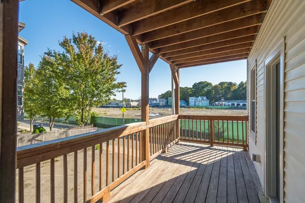 a view of balcony with wooden floor