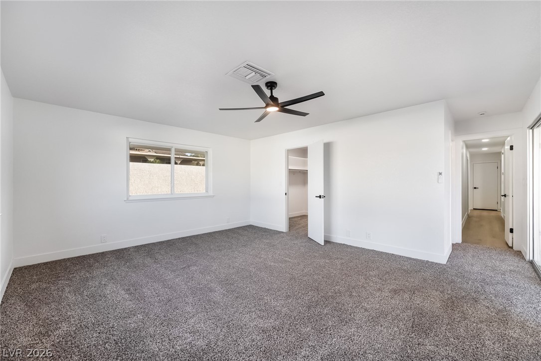 429 Crestway Road Henderson, NV 89015 - Photo 24 of 56 A well-lit bedroom features plush carpeting and a modern ceiling fan for ultimate comfort.
