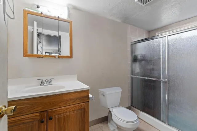 a bathroom with a sink a toilet and mirror