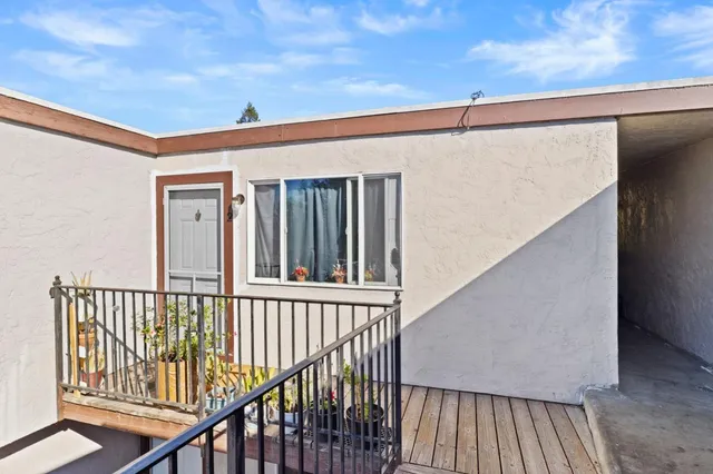 a kitchen with stainless steel appliances granite countertop a sink a stove and a dining table