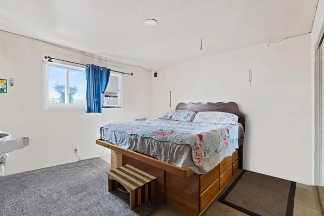 a bedroom with a bed and window