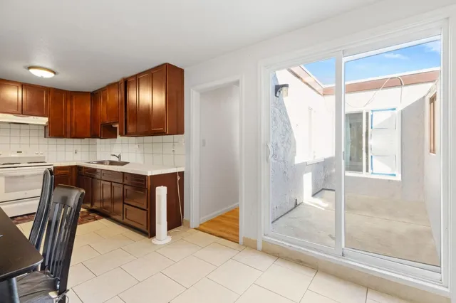 a view of a kitchen with dining table and chairs