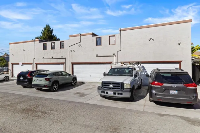 a car parked in front of a white house