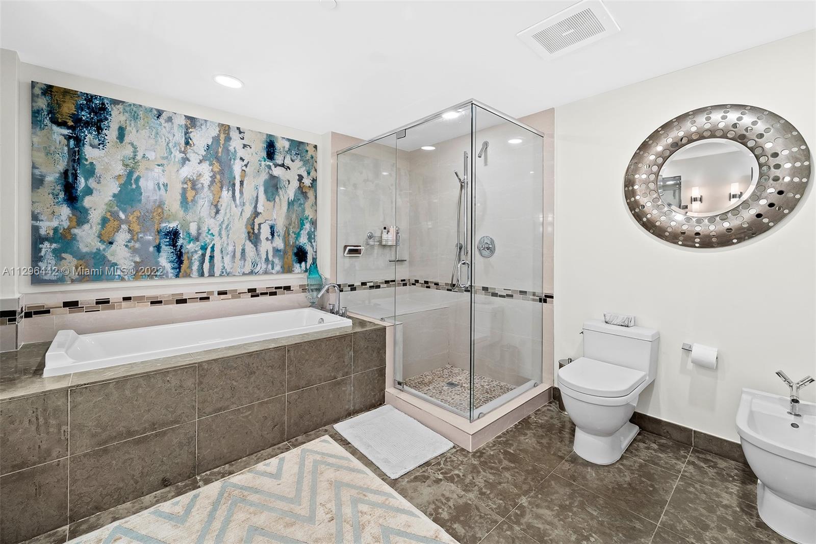 495 Brickell Avenue, Unit BAY405 Miami, FL 33131 - Photo 11 of 25 a bathroom with a toilet a sink and a shower